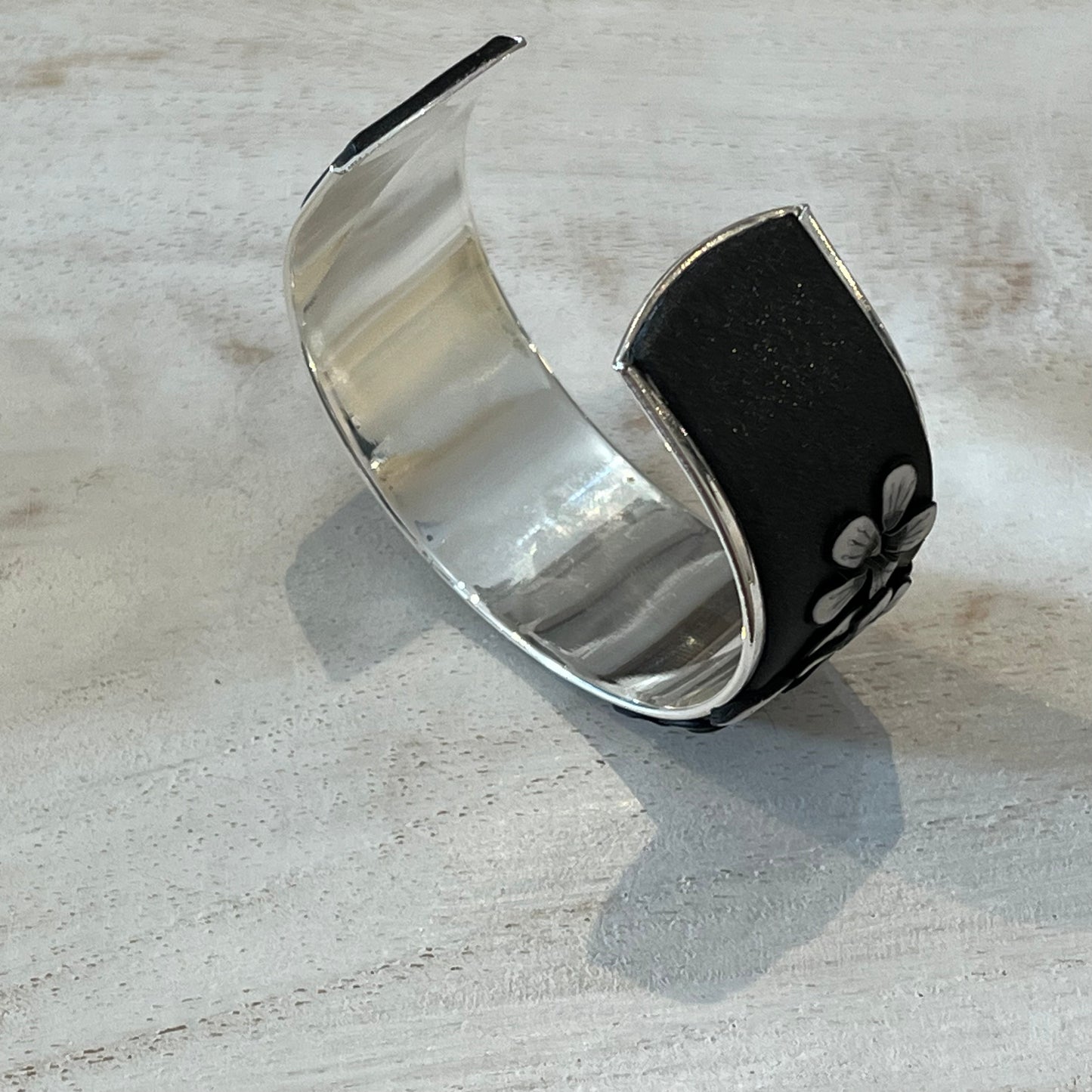 Moonlit Shimmer Blossom Cuff by Stephanie Fraselle featuring polymer clay florals and Swarovski crystals, handcrafted in Lanzarote