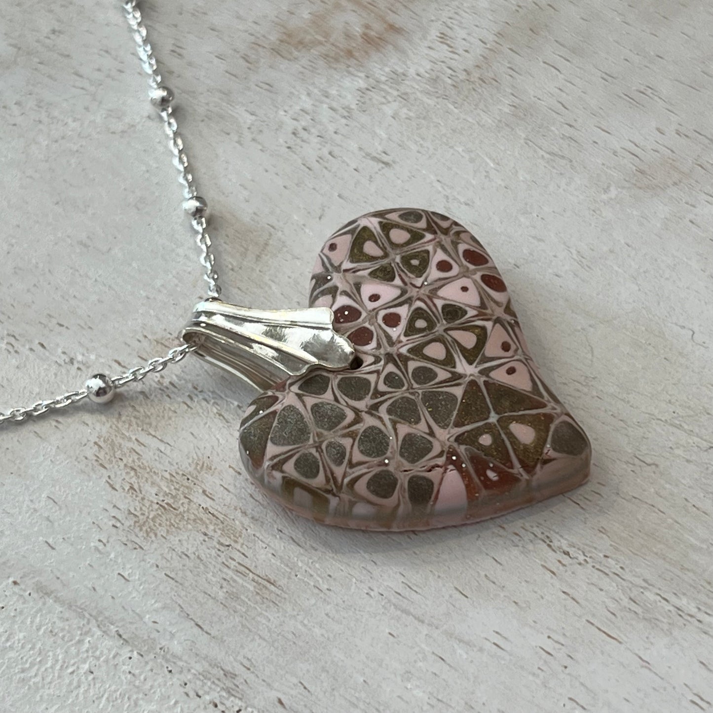 Artisan necklace with a rose-toned mosaic heart pendant, handcrafted in Europe with sterling silver beads by Stephanie Fraselle.