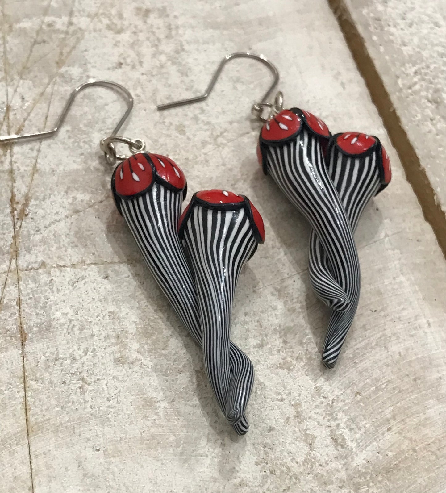 Handmade black and white pinstripe Soul Mates earrings by Lanzarote artisan Stephanie Fraselle with polymer clay flowers and sterling silver accents