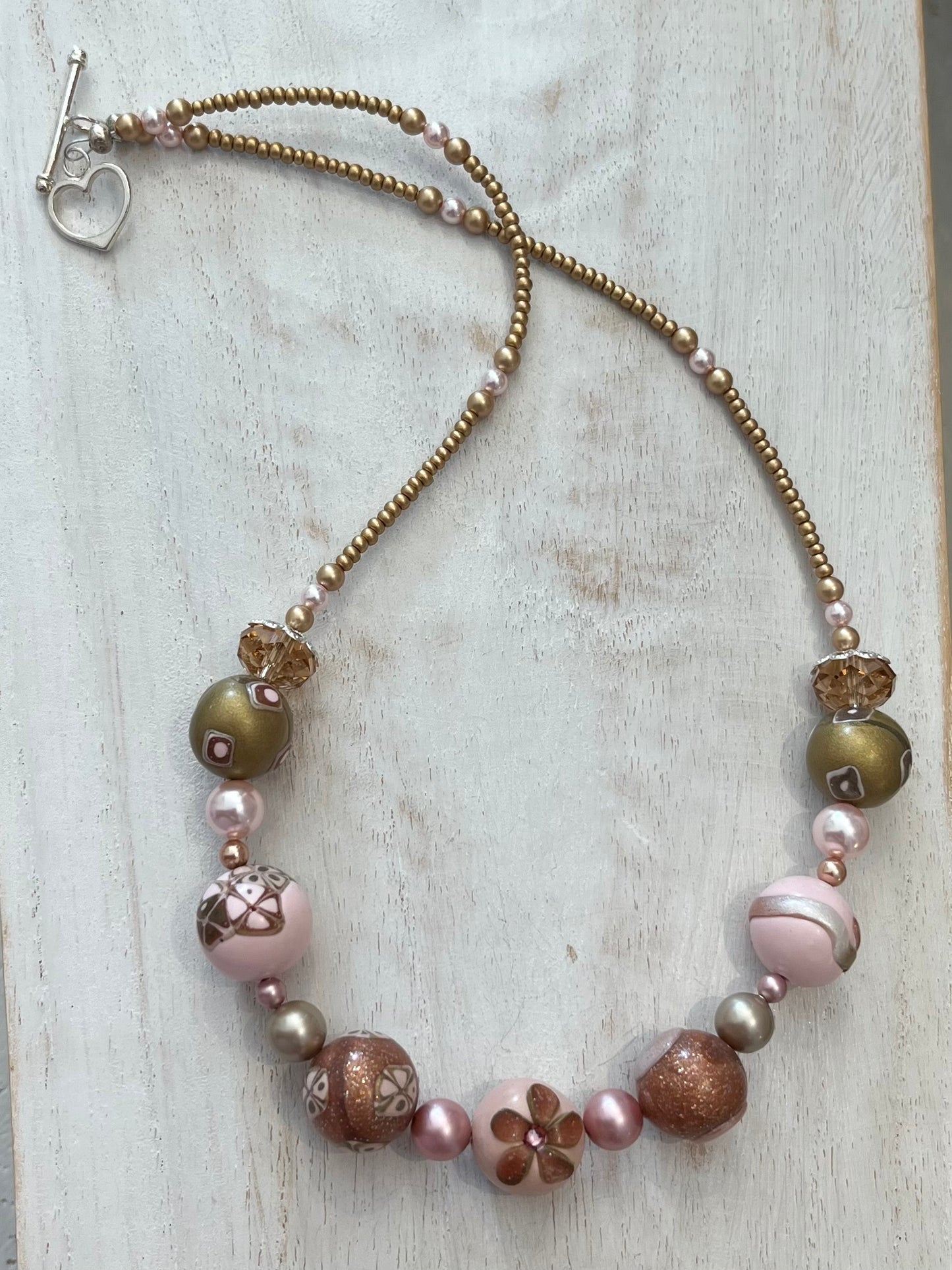 Artisan necklace inspired by The Empress, with hand-sculpted rose-toned beads, Swarovski elements, and sterling silver by Stephanie Fraselle.