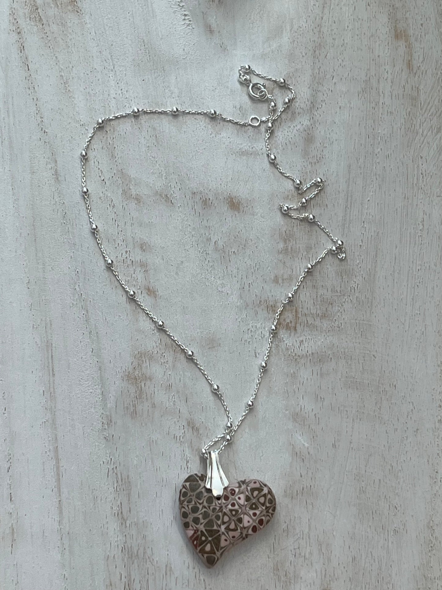 Artisan necklace with a rose-toned mosaic heart pendant, handcrafted in Europe with sterling silver beads by Stephanie Fraselle.