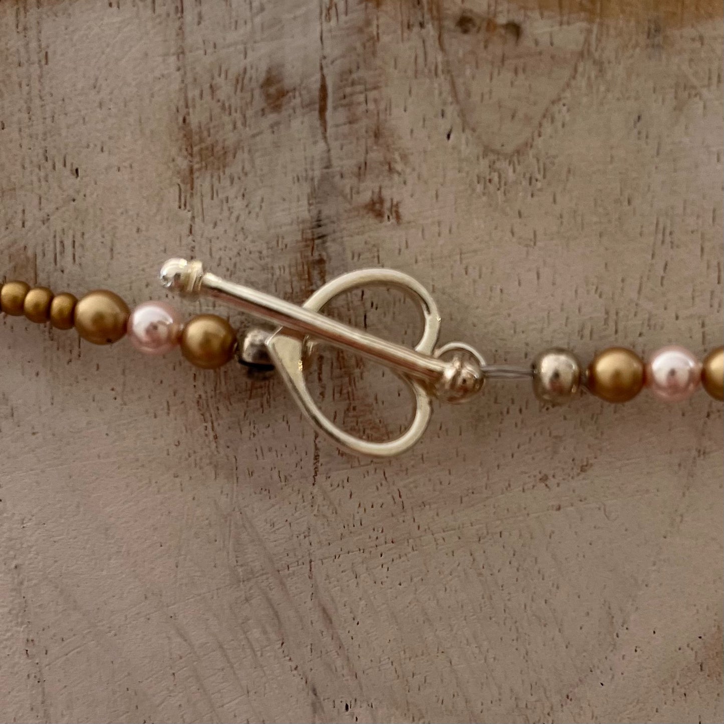 Artisan necklace inspired by The Empress, with hand-sculpted rose-toned beads, Swarovski elements, and sterling silver by Stephanie Fraselle.