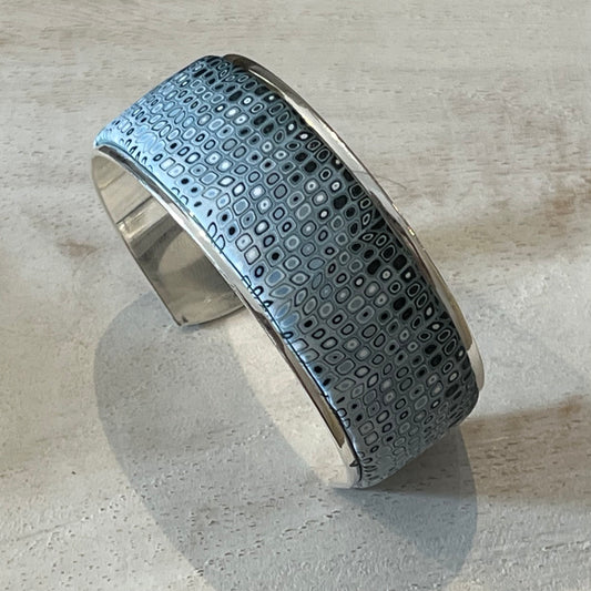 Handcrafted Sea Foam mosaic cuff by Stephanie Fraselle, featuring layered polymer clay canes in ocean-inspired patterns with sterling silver galvanized brass finish, adjustable fit, and hypoallergenic materials.