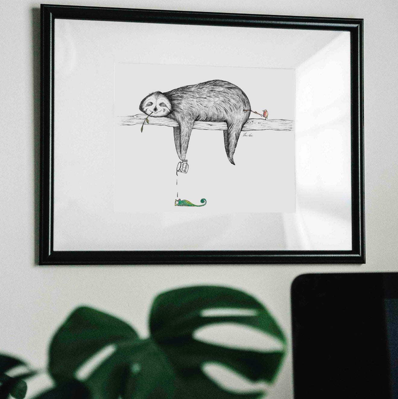 Unframed art print of a relaxed sloth hanging on a log, holding a ‘Carpe Diem’ cup dripping onto a chameleon, while a small bird pokes the sloth’s bottom.