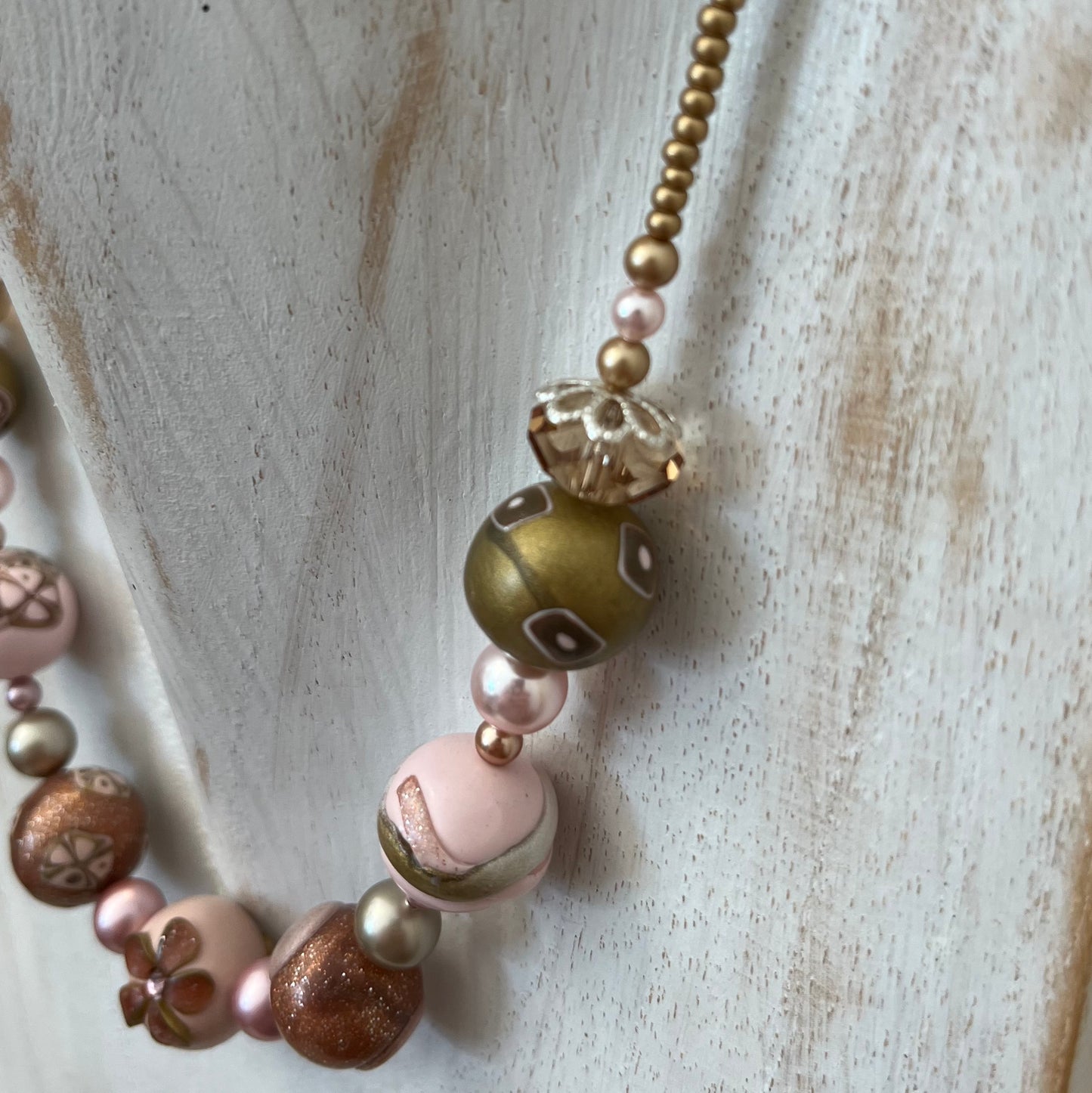Artisan necklace inspired by The Empress, with hand-sculpted rose-toned beads, Swarovski elements, and sterling silver by Stephanie Fraselle.