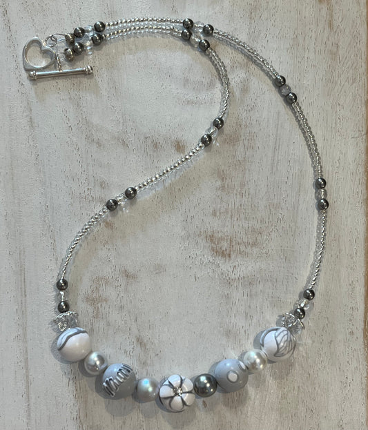 White Blossom Necklace by Stephanie Fraselle with five sculpted polymer clay beads in soft white and grey, accented by Swarovski crystals, pearls, and sterling silver clasp