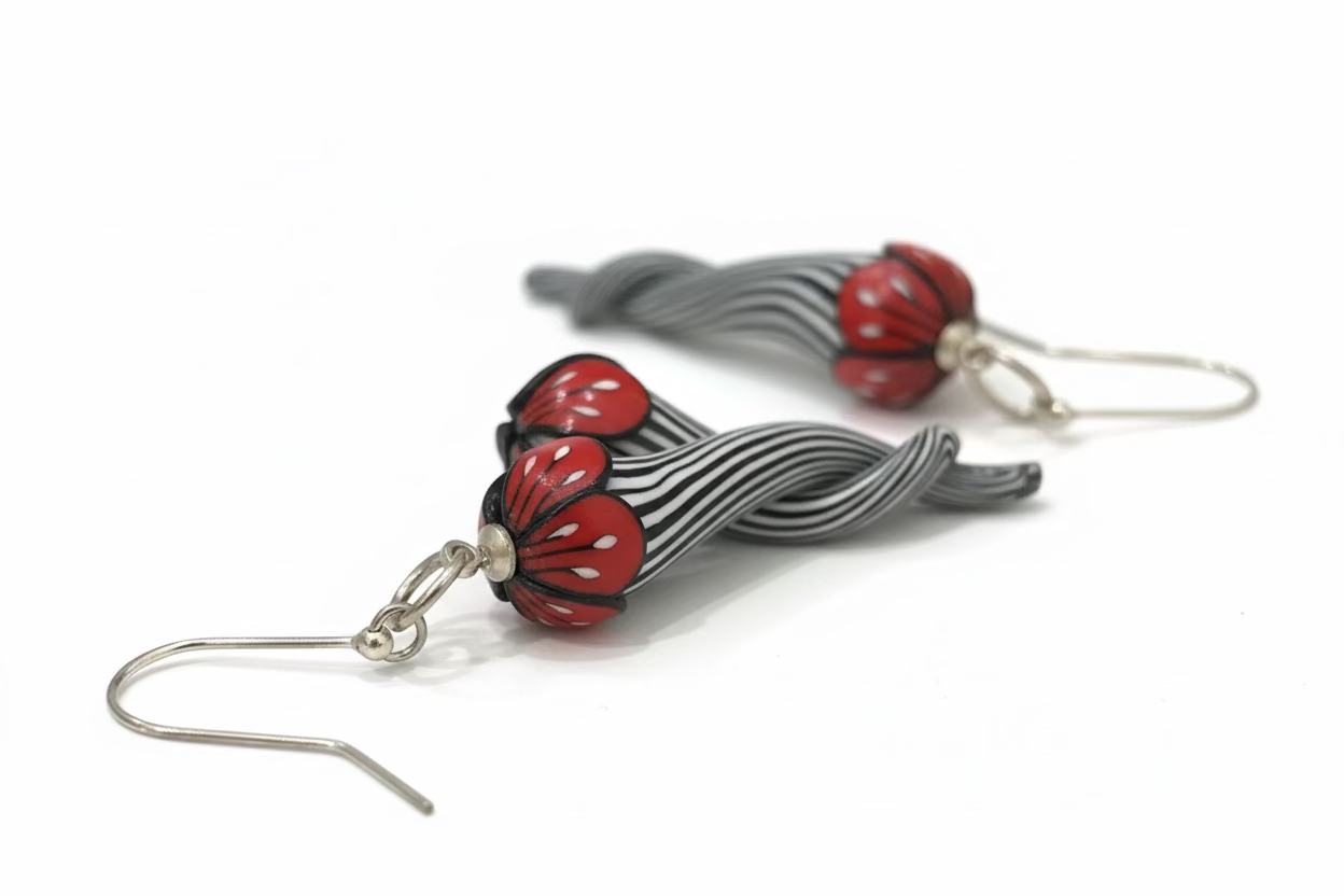 Handmade black and white pinstripe Soul Mates earrings by Lanzarote artisan Stephanie Fraselle with polymer clay flowers and sterling silver accents