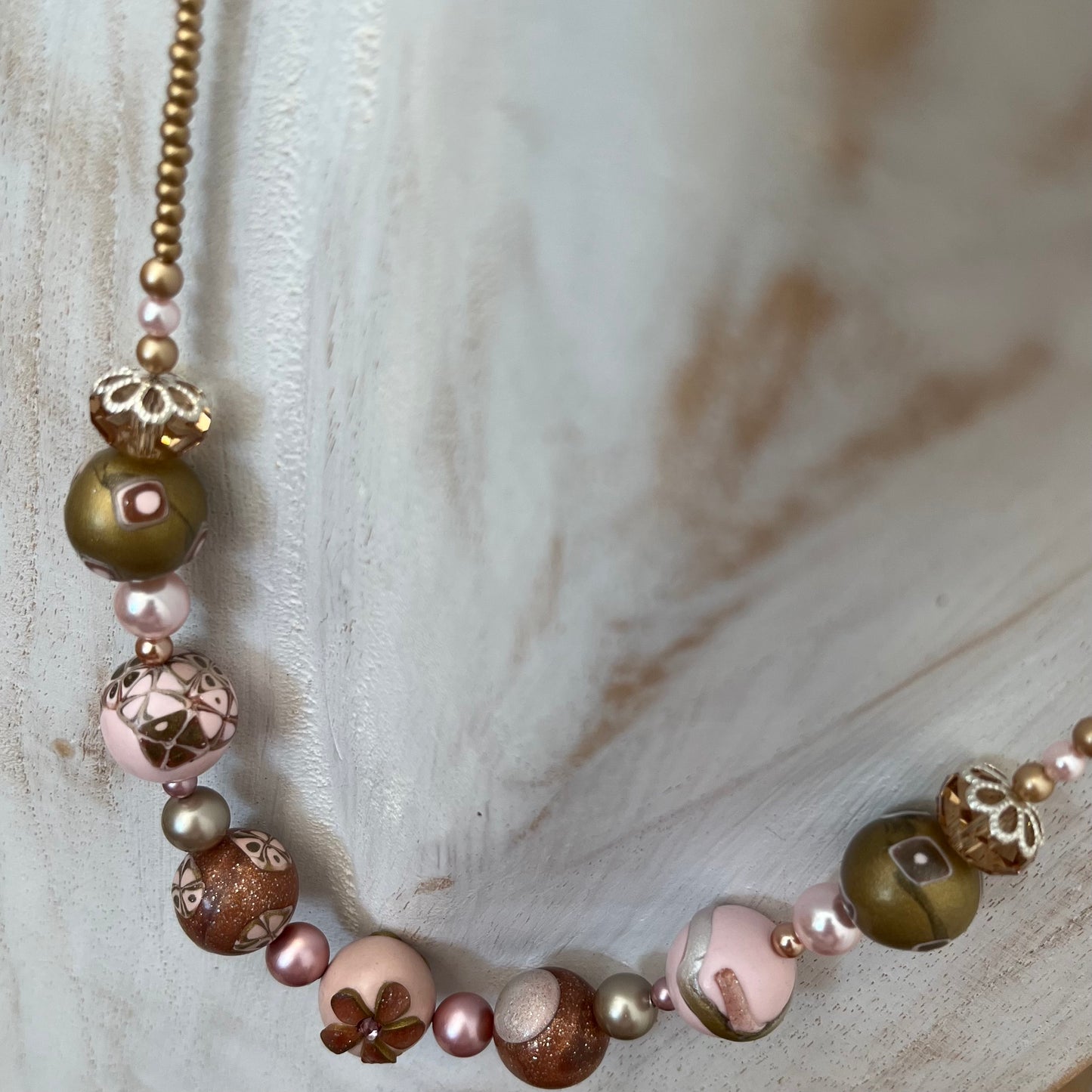Artisan necklace inspired by The Empress, with hand-sculpted rose-toned beads, Swarovski elements, and sterling silver by Stephanie Fraselle.