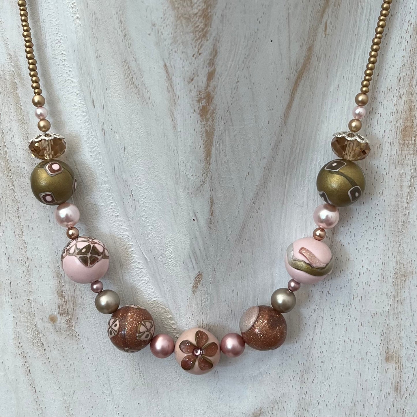 Artisan necklace inspired by The Empress, with hand-sculpted rose-toned beads, Swarovski elements, and sterling silver by Stephanie Fraselle.