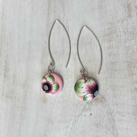 Handmade polymer clay medallion earrings by Stephanie Fraselle featuring watercolor-inspired floral design on pale pink background
