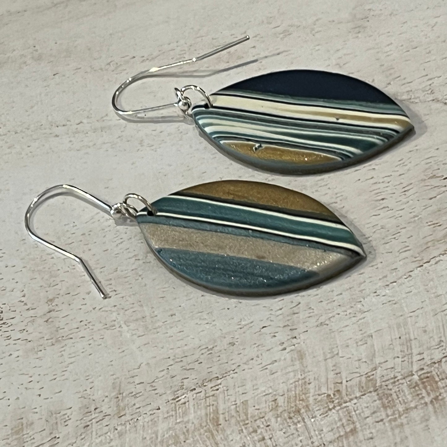 Asymmetric Nocturne earring drops by Stephanie Fraselle with gold, pearl, and petrol blue accents handmade in Lanzarote