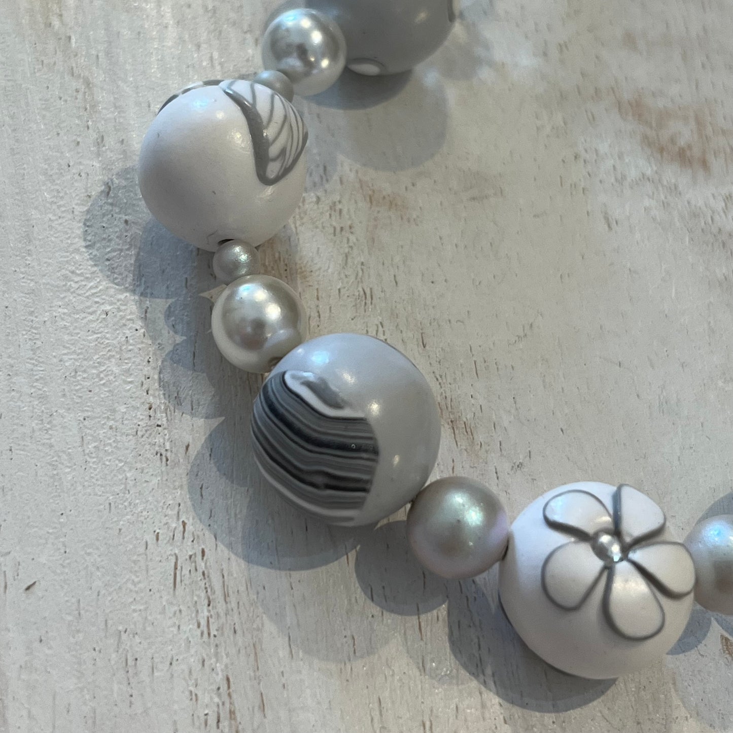 White Blossom Collection Necklace by Stephanie Fraselle, featuring handcrafted polymer clay floral beads, Swarovski crystals, sterling silver clasp, and delicate leaf motifs