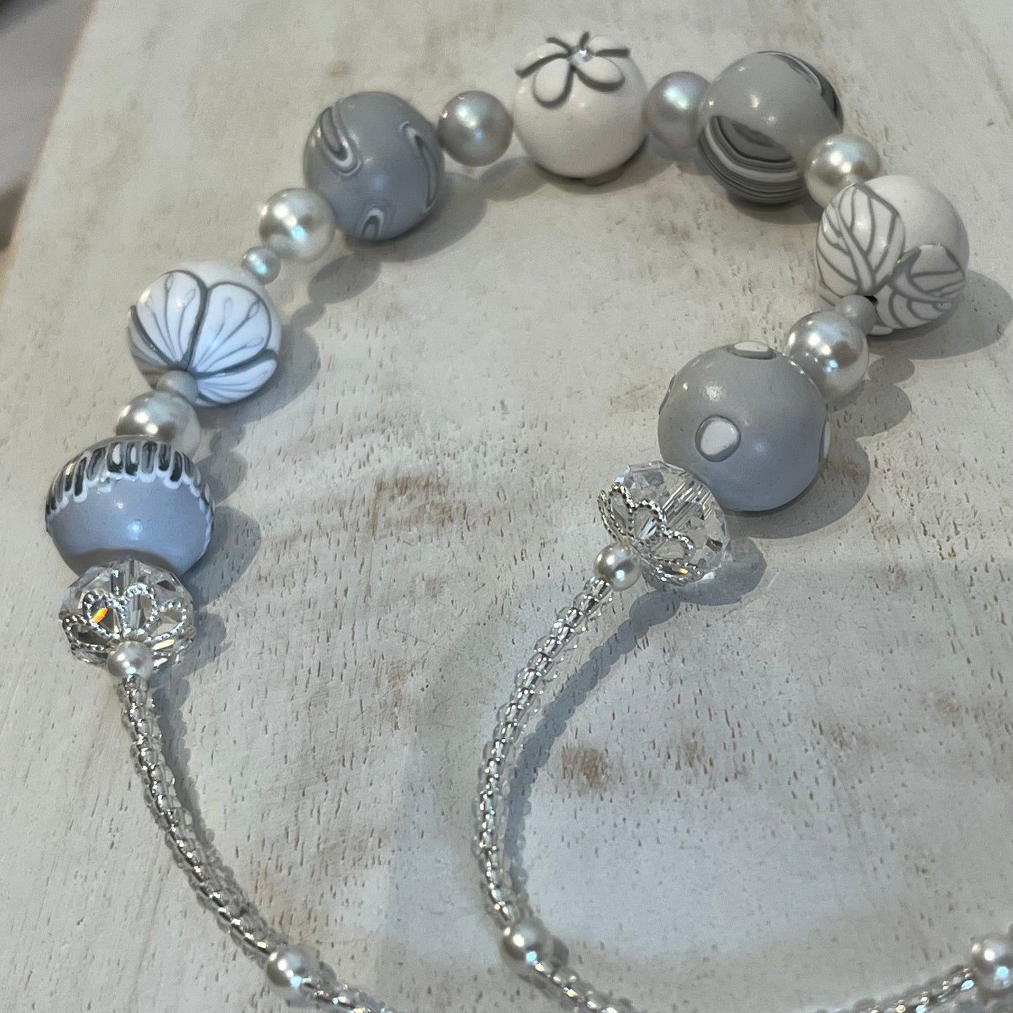White Blossom Collection Necklace by Stephanie Fraselle, featuring handcrafted polymer clay floral beads, Swarovski crystals, sterling silver clasp, and delicate leaf motifs