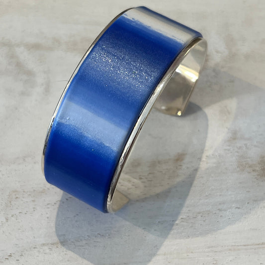 Handcrafted polymer clay cuff in sapphire blue, navy, ultramarine, and pearl white from Stephanie Fraselle’s Ocean Shimmer Collection.