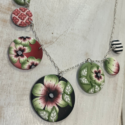 Handcrafted seven-medallion floral necklace in layered polymer clay with watercolour petals and sterling silver chain by Stephanie Fraselle