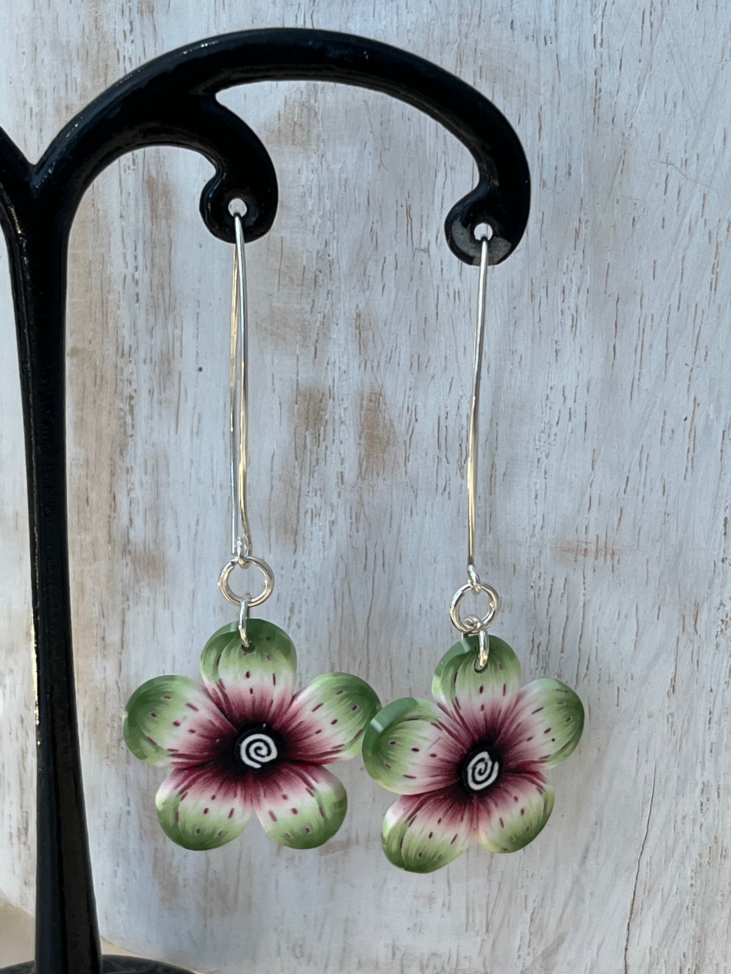 Lightweight polymer clay floral earrings with watercolor-blended petals in crimson, pink, black, and sage, on sterling silver drops by Stephanie Fraselle