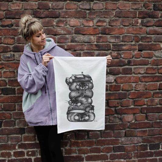 Linen tea towel with a playful illustration of a stack of chubby hamsters piled on top of each other