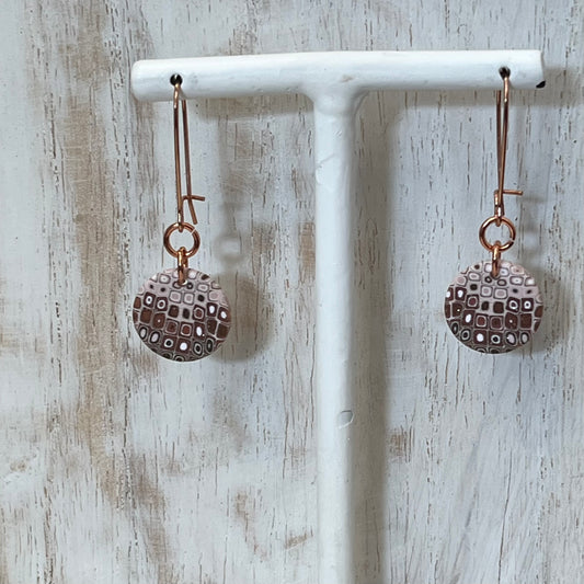 Rose‑gold tone earrings with hand‑sculpted dusky pink and gold mosaic medallions suspended from slender drops