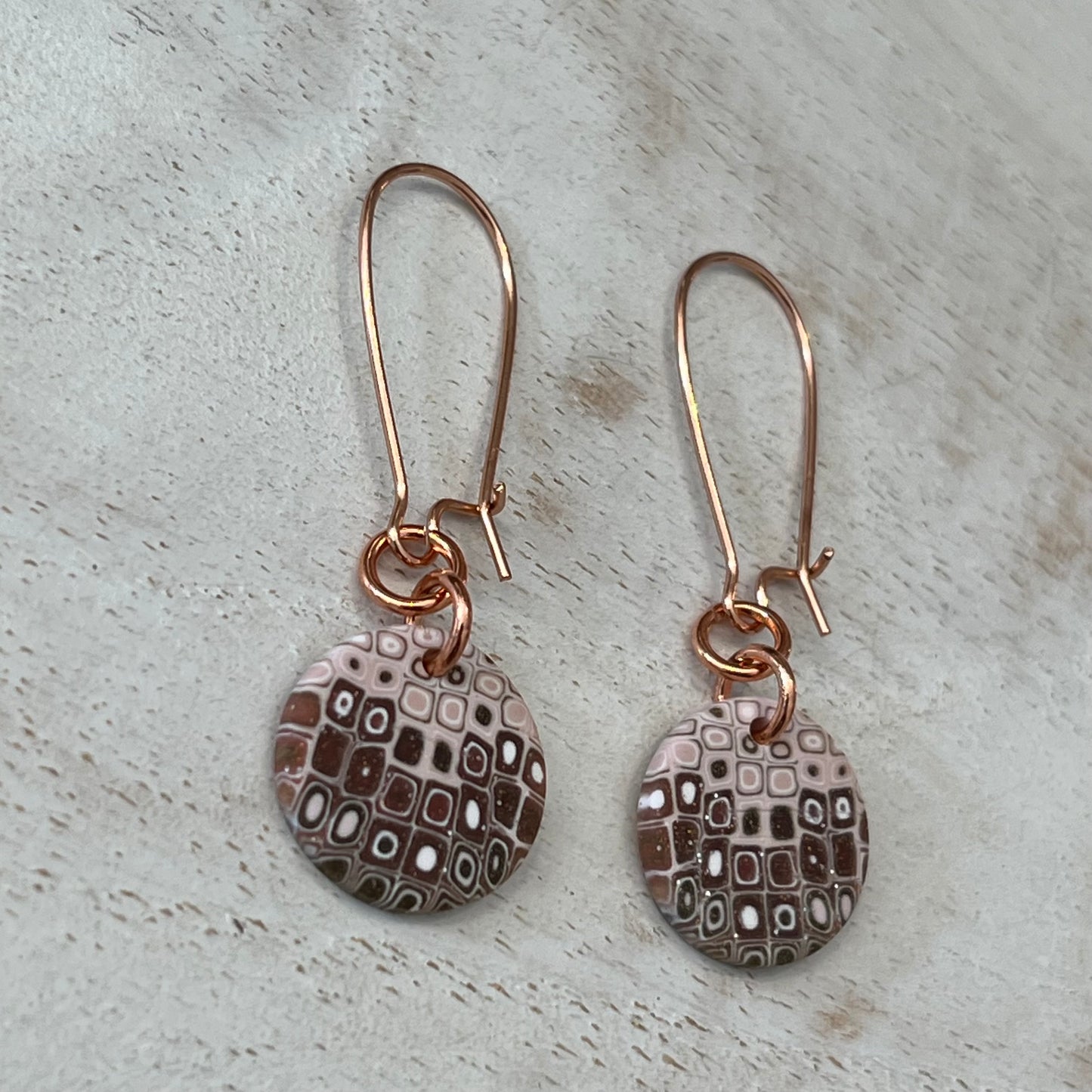 Rose‑gold tone earrings with hand‑sculpted dusky pink and gold mosaic medallions suspended from slender drops