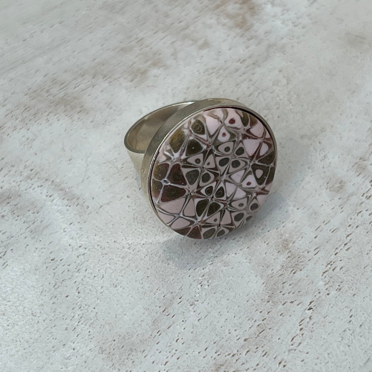 the Rose Gold Mosaic Ring by Stephanie Fraselle features hand-sculpted polymer clay stripes on a sterling silver plated brass base. Adjustable fit. Elegant, nickel-free, and handmade in Lanzarote.