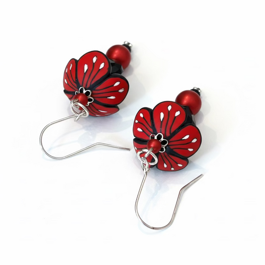 Close-up of Stephanie Fraselle’s Magic Moments Blossom Earrings – handcrafted red, white, and black polymer clay flowers with Swarovski crystal and pearl accents on sterling silver stems