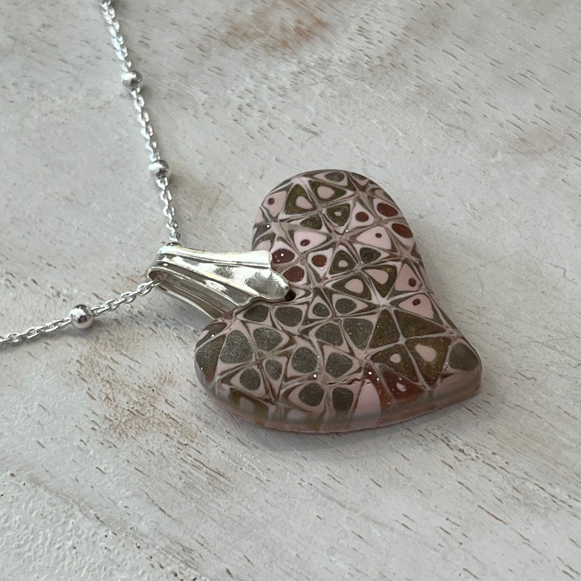 Artisan necklace with a rose-toned mosaic heart pendant, handcrafted in Europe with sterling silver beads by Stephanie Fraselle.