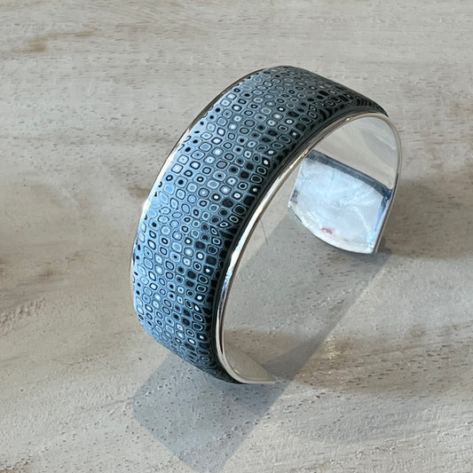 Handcrafted Sea Foam mosaic cuff by Stephanie Fraselle, featuring layered polymer clay canes in ocean-inspired patterns with sterling silver galvanized brass finish, adjustable fit, and hypoallergenic materials.