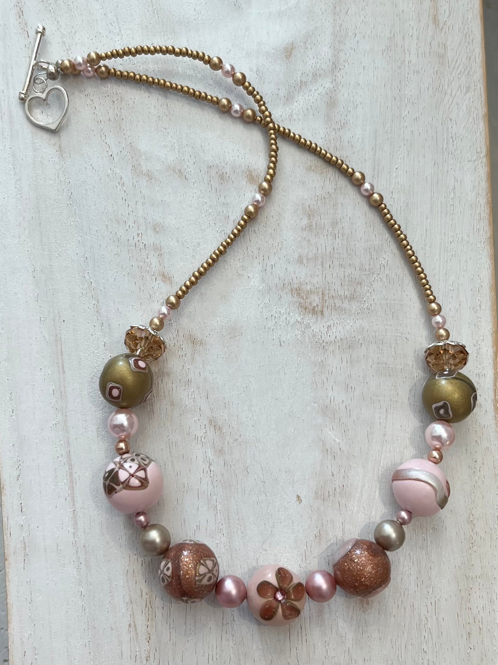 Artisan necklace inspired by The Empress, with hand-sculpted rose-toned beads, Swarovski elements, and sterling silver by Stephanie Fraselle.