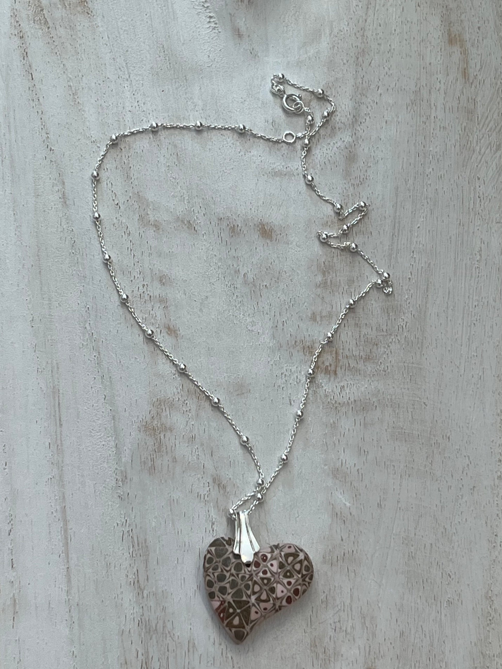Artisan necklace with a rose-toned mosaic heart pendant, handcrafted in Europe with sterling silver beads by Stephanie Fraselle.