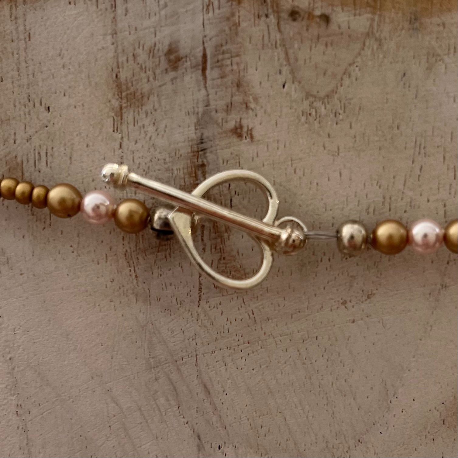 Artisan necklace inspired by The Empress, with hand-sculpted rose-toned beads, Swarovski elements, and sterling silver by Stephanie Fraselle.