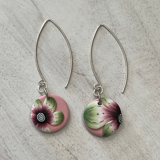 Handmade polymer clay medallion earrings by Stephanie Fraselle featuring watercolor-inspired floral design on pale pink background