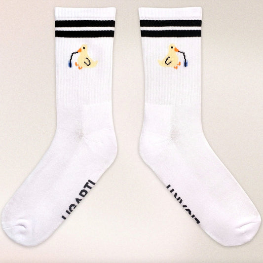 Minimalist cotton socks featuring Piet the Sippy Duck sipping from a cup with a straw, inspired by Hanna’s artwork