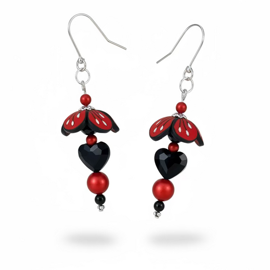 Close-up of Stephanie Fraselle’s Magic Moments Blossom Earrings – handcrafted red, white, and black polymer clay flowers with Swarovski crystal and pearl accents on sterling silver stems