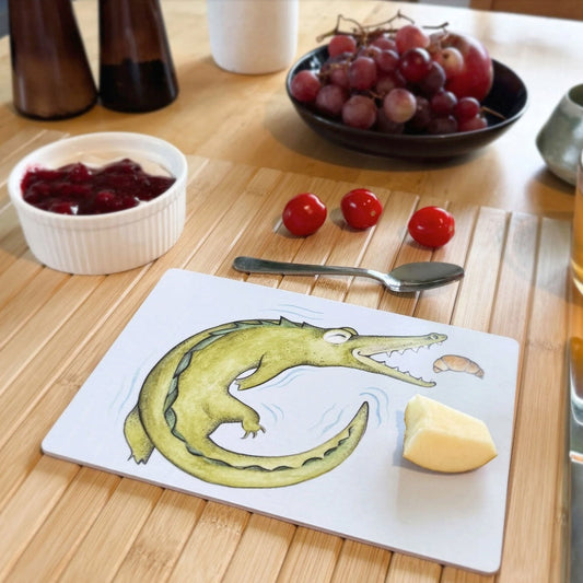 Wooden breakfast board with Hanna’s crocodile and croissant illustration, handcrafted in Sweden from sustainable forestry