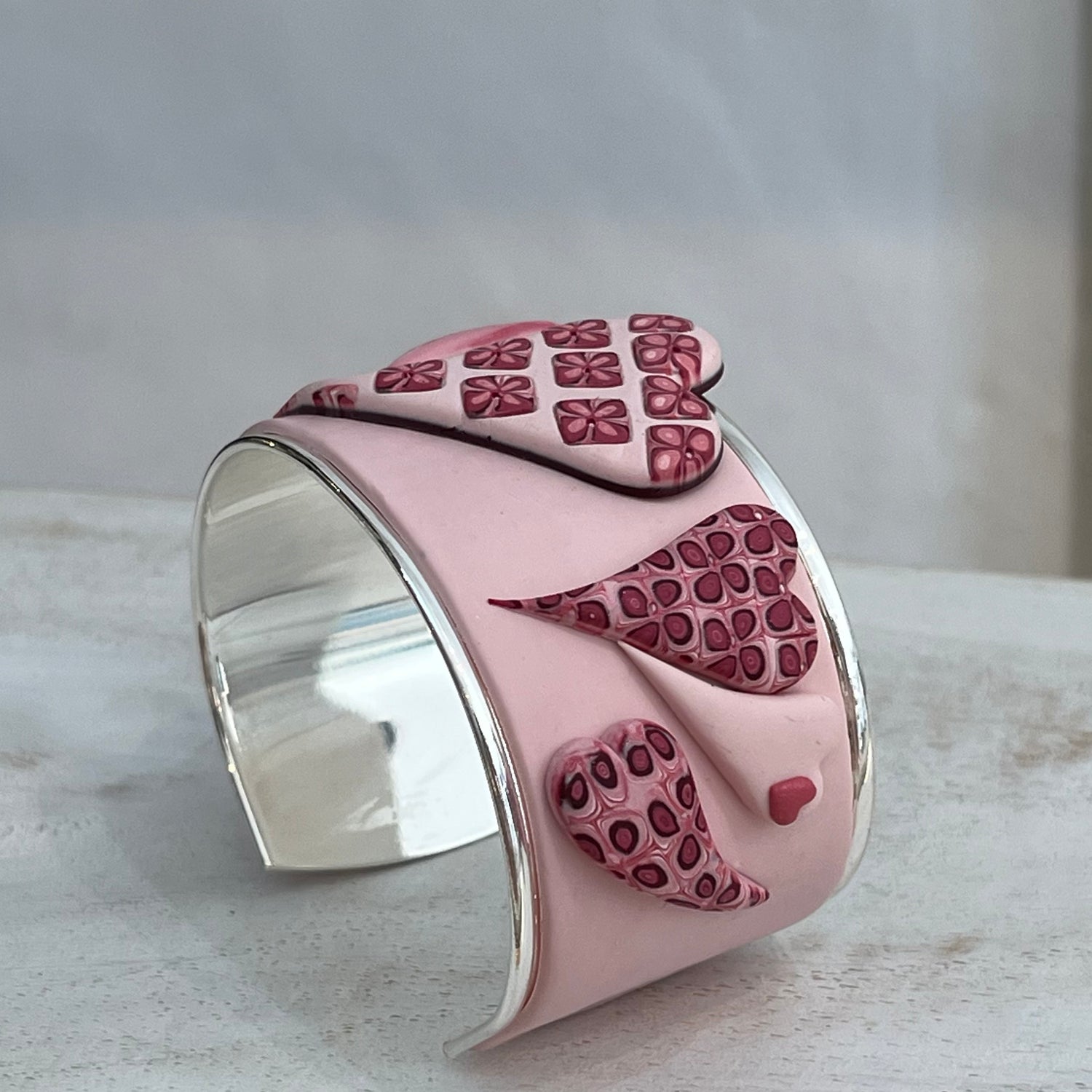 Stephanie Fraselle handcrafted polymer clay love heart bracelet cuff in crimson pink tones