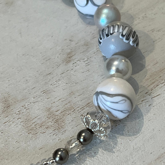 White Blossom Necklace by Stephanie Fraselle with five sculpted polymer clay beads in soft white and grey, accented by Swarovski crystals, pearls, and sterling silver clasp