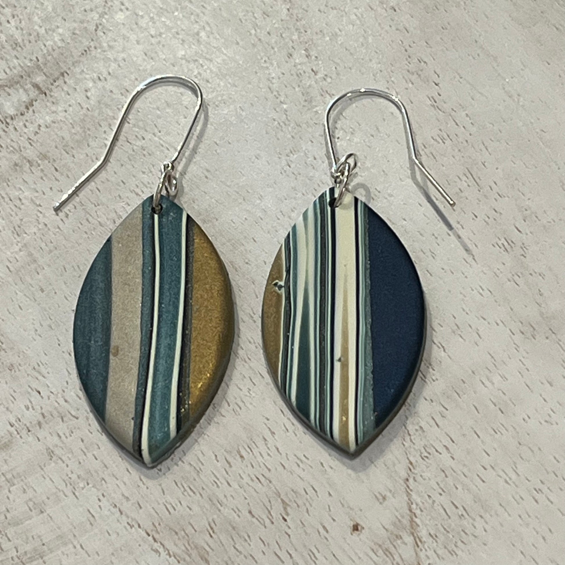 Asymmetric Nocturne earring drops by Stephanie Fraselle with gold, pearl, and petrol blue accents handmade in Lanzarote