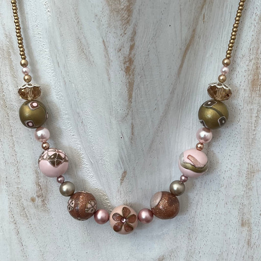 Artisan necklace inspired by The Empress, with hand-sculpted rose-toned beads, Swarovski elements, and sterling silver by Stephanie Fraselle.