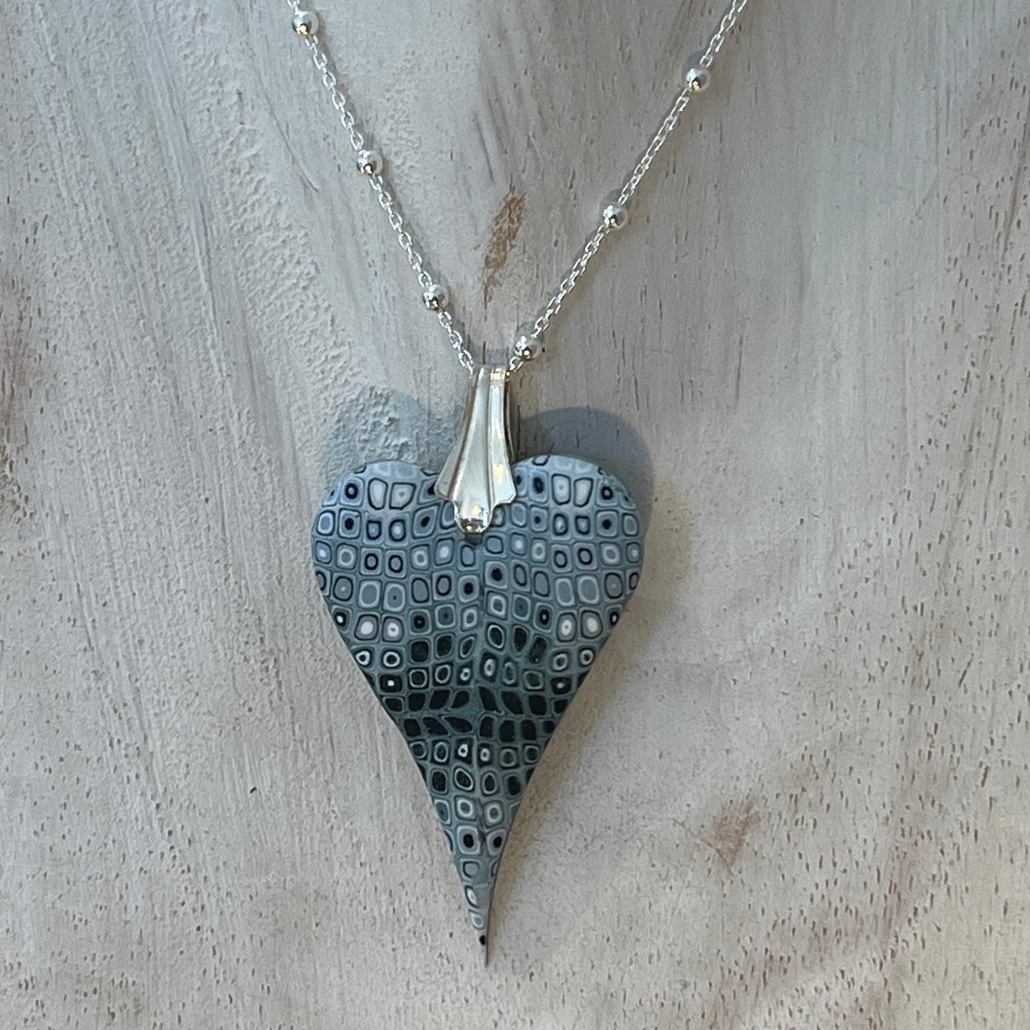 Curved Sculpted Heart pendant by Stephanie Fraselle, handmade in layered polymer clay on a sterling silver chain