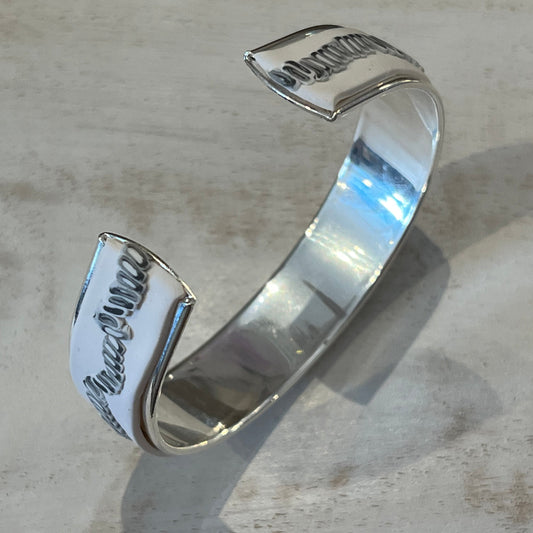 White Blossom Mosaic Cuff by Stephanie Fraselle featuring a matte white band and a linear mosaic of grey and white tiles, handcrafted from polymer clay with slight adjustability and a sterling silver-plated finish.