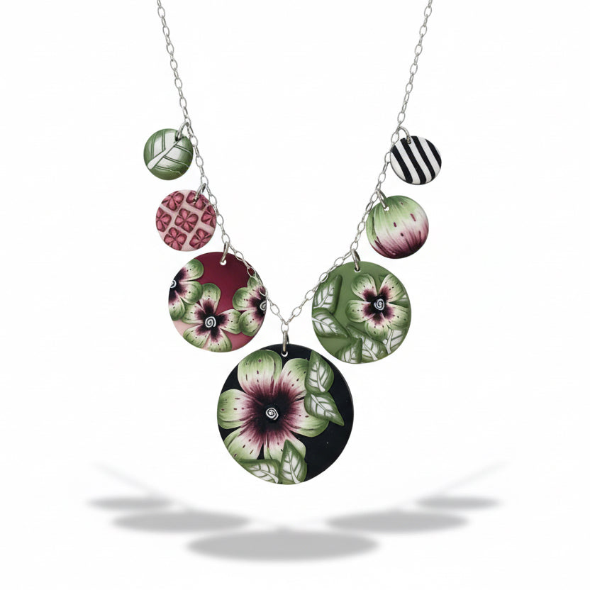 Handcrafted seven-medallion floral necklace in layered polymer clay with watercolour petals and sterling silver chain by Stephanie Fraselle
