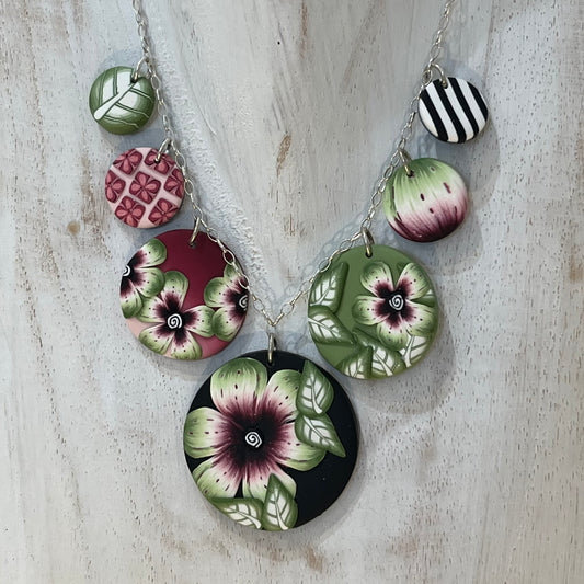 Handcrafted seven-medallion floral necklace in layered polymer clay with watercolour petals and sterling silver chain by Stephanie Fraselle
