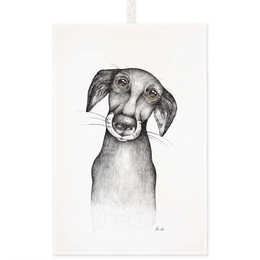 Illustration of a dog with a devoted, soulful expression printed on a linen tea towel