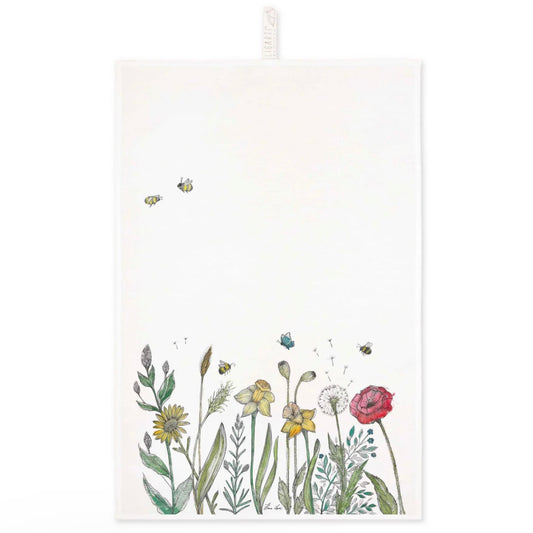Colourful illustration of a wildflower meadow with bees printed on a linen tea towel
