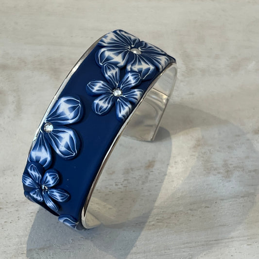 Midnight Bloom Cuff by Stephanie Fraselle with navy and white floral polymer clay, Swarovski pearls, and sterling silver finish