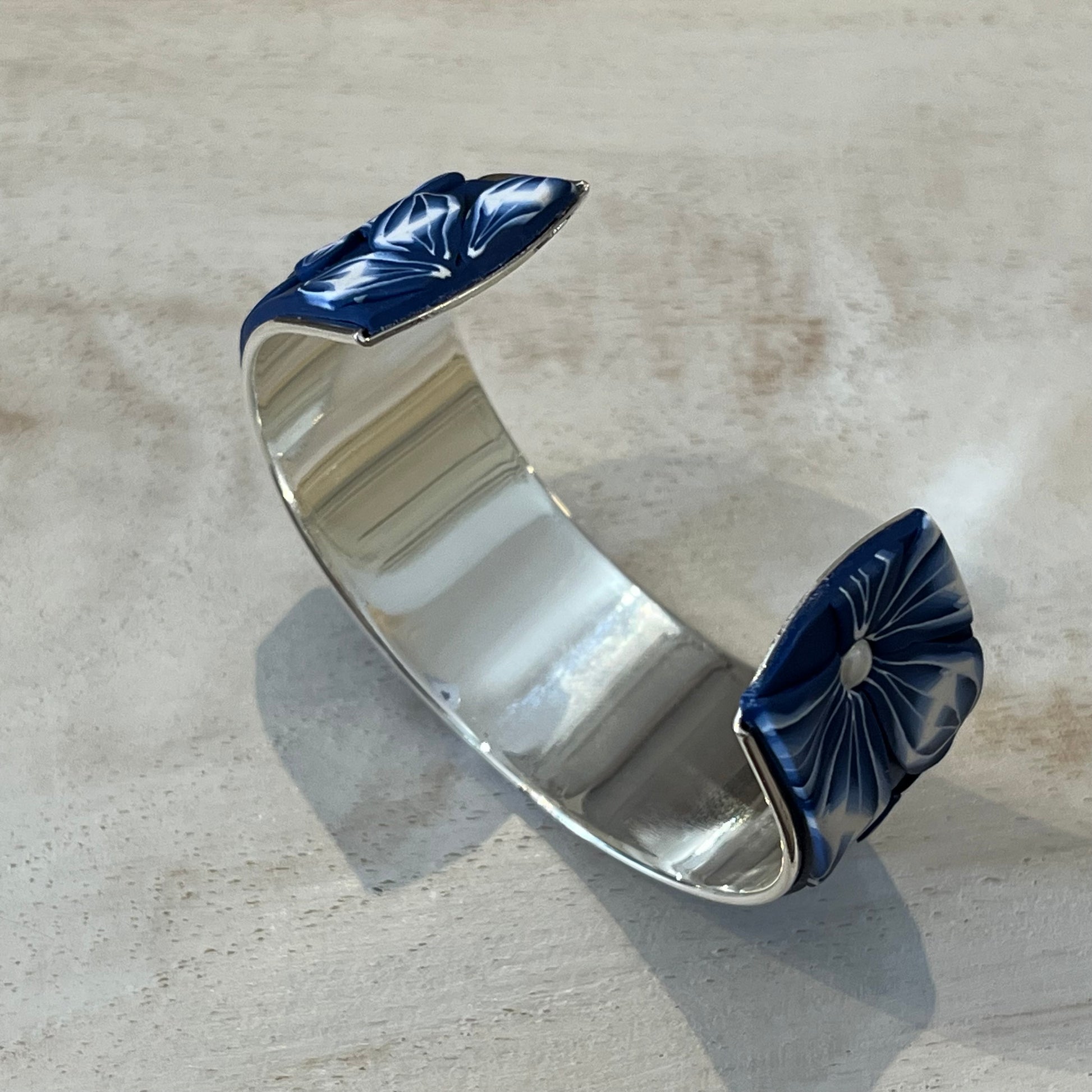Midnight Bloom Cuff by Stephanie Fraselle with navy and white floral polymer clay, Swarovski pearls, and sterling silver finish