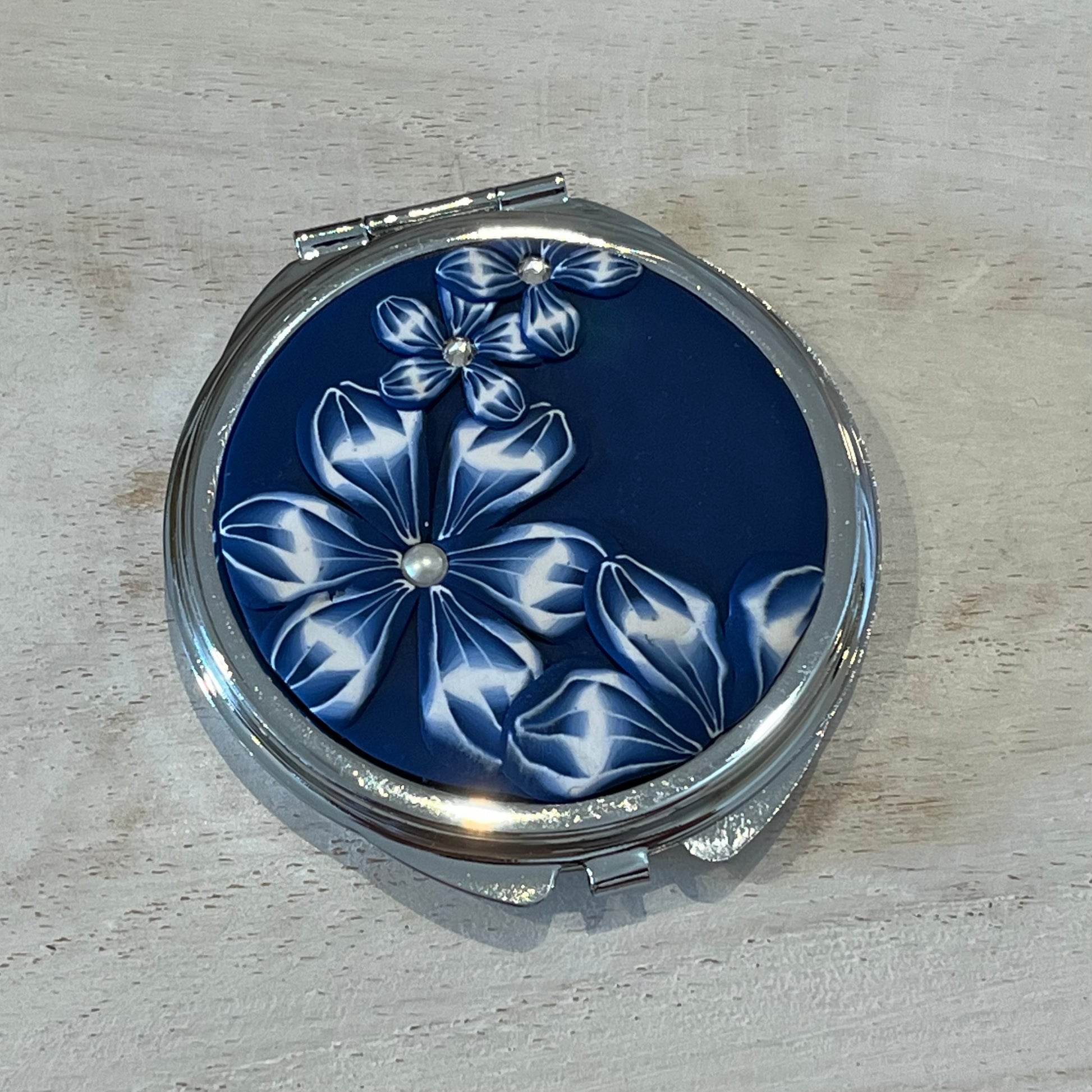 Navy Blue Floral Bloom Pocket Mirror by Stephanie Fraselle, handcrafted in polymer clay with Swarovski crystal accents