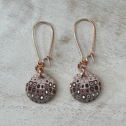 Rose‑gold tone earrings with hand‑sculpted dusky pink and gold mosaic medallions suspended from slender drops