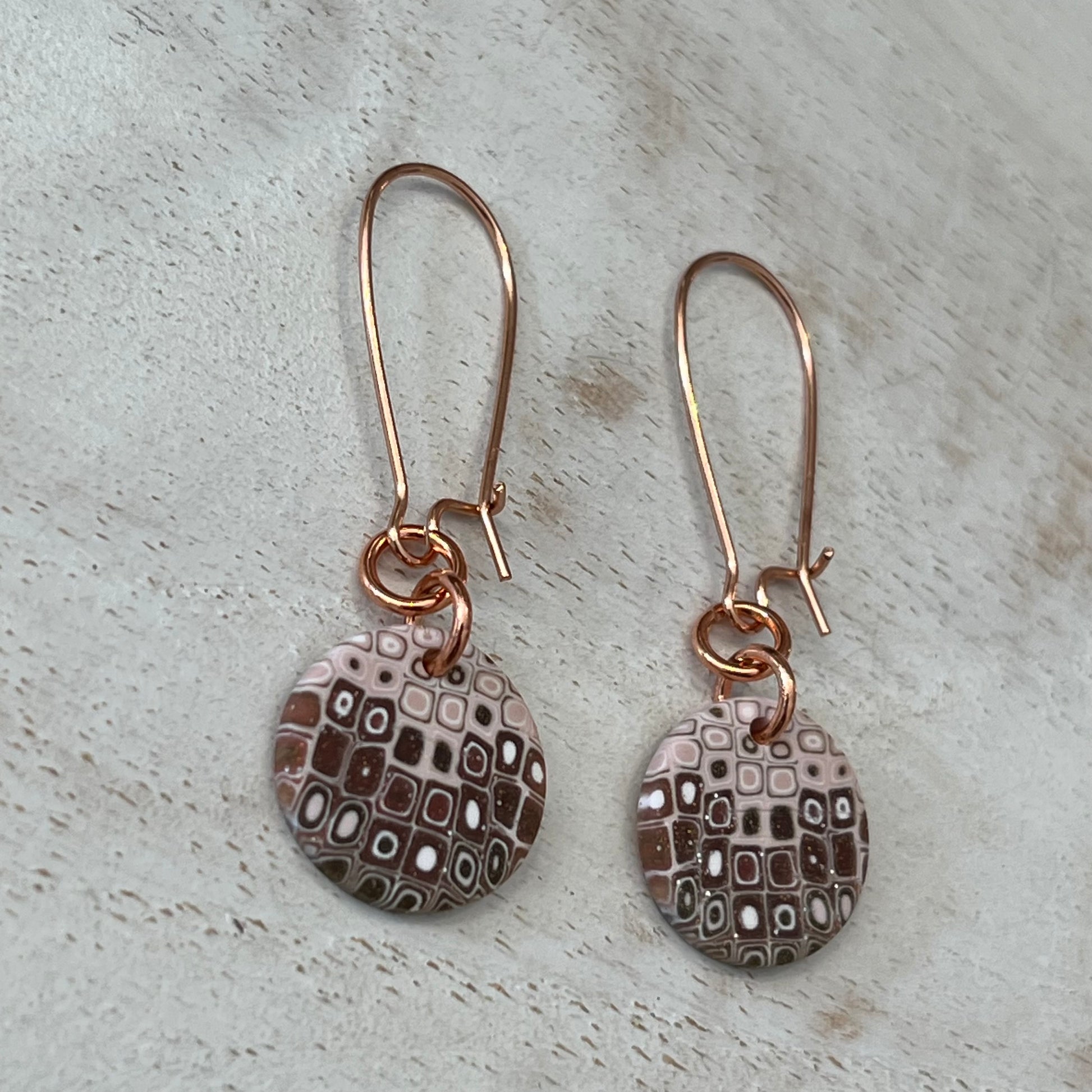 Rose‑gold tone earrings with hand‑sculpted dusky pink and gold mosaic medallions suspended from slender drops