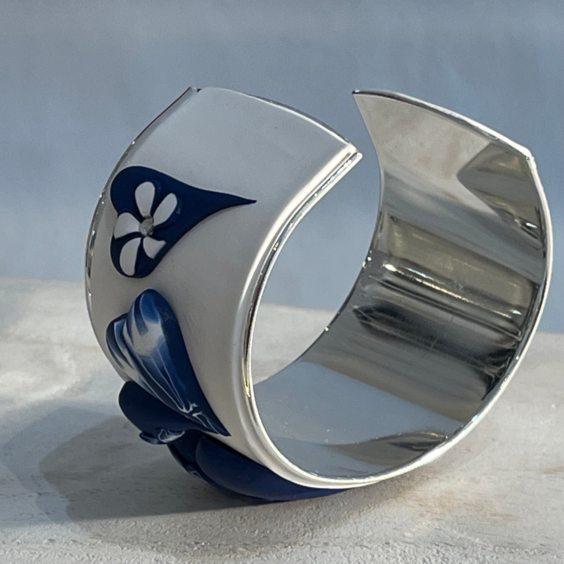 Hand-sculpted navy and white love heart bracelet cuff in polymer clay by Stephanie Fraselle, featuring raised heart motifs and silver-plated interior.